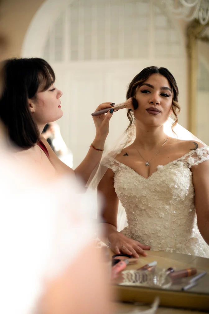 Woman Applying Makeup to Bride's Face 